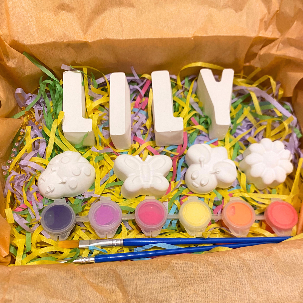 Flat lay of Garden Friends paint kit with bee, butterfly, ladybird and flower moulds, paints and brush