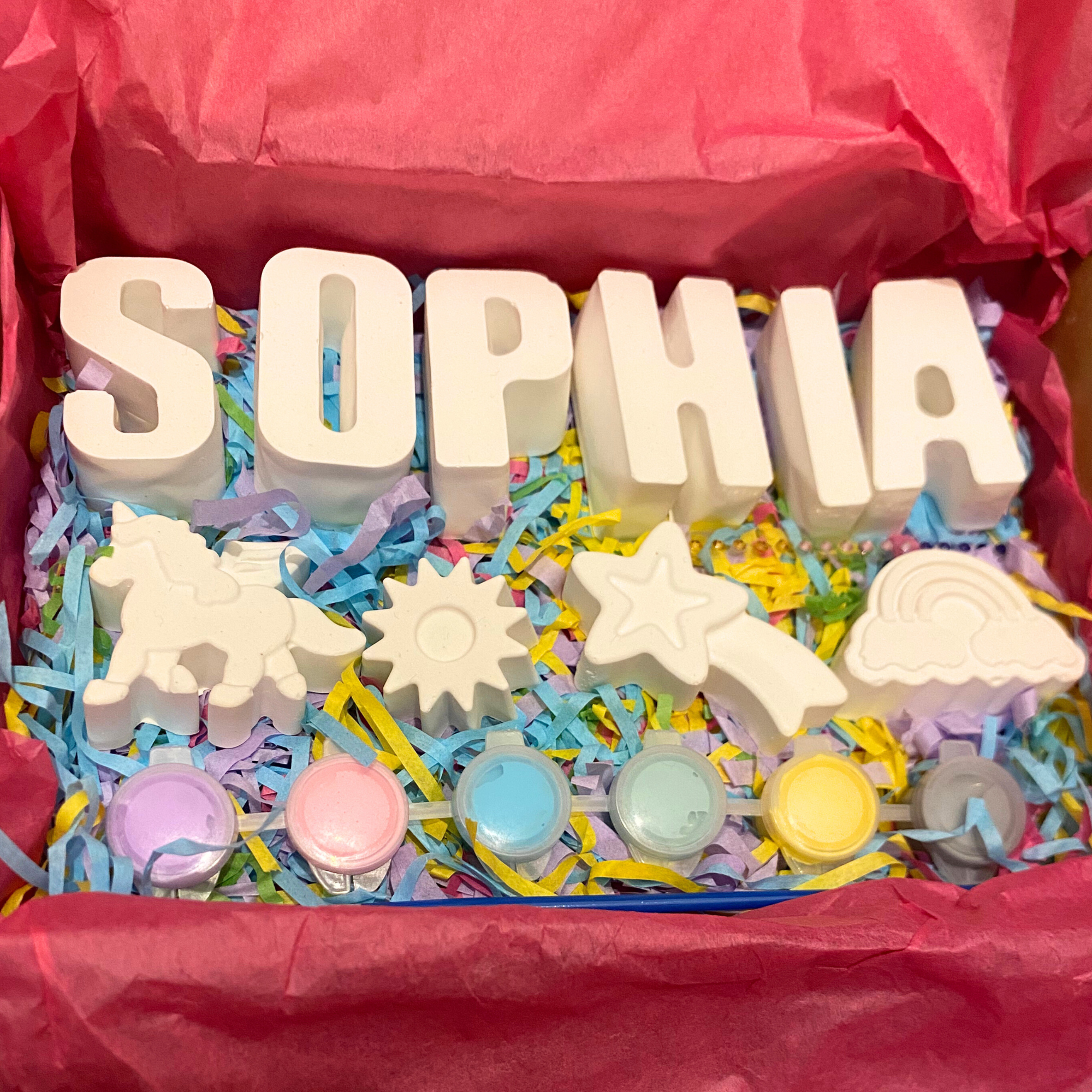 Unicorn paint kit with unicorn moulds, paints and brush displayed flat lay