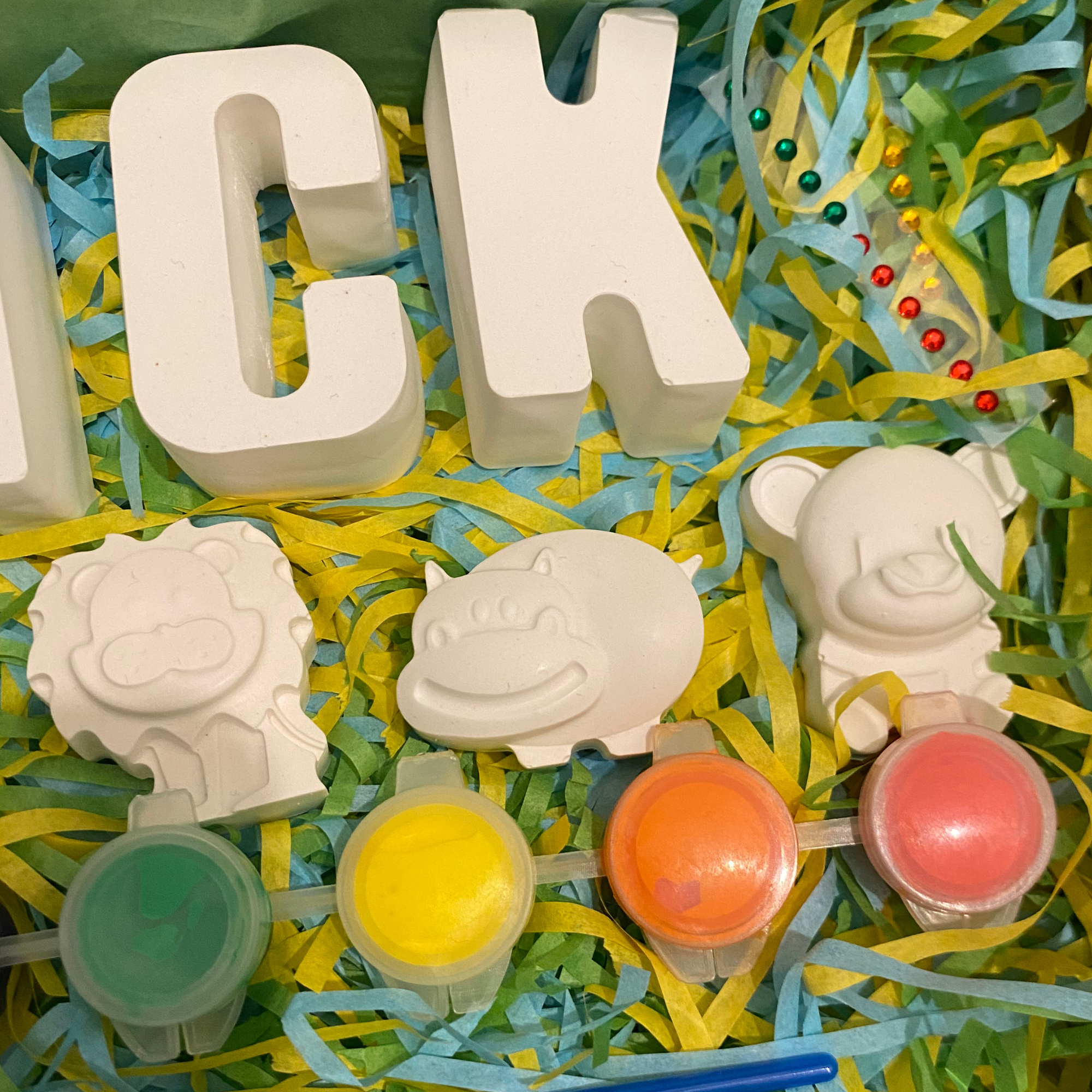 Close-up of painted lion, bear and elephant moulds from animal paint kit