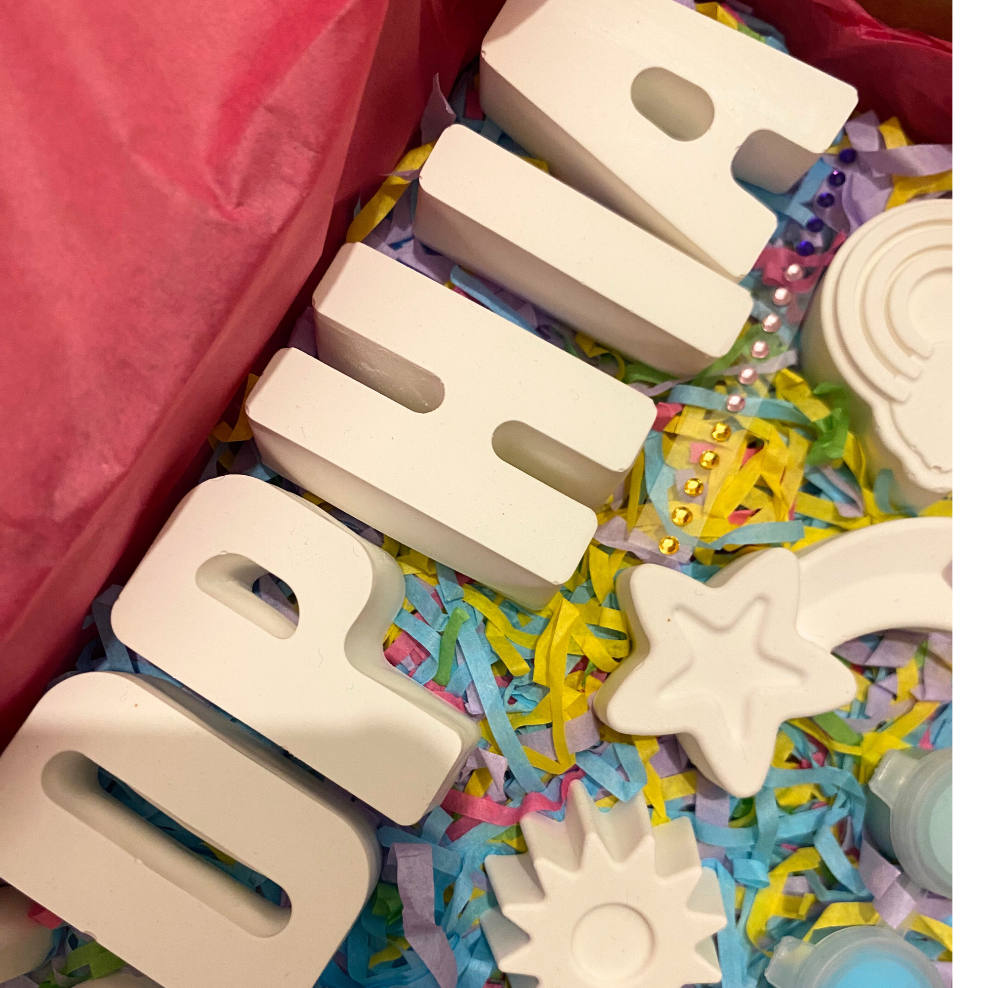 Unicorn paint kit with unicorn moulds, paints and brush displayed flat lay